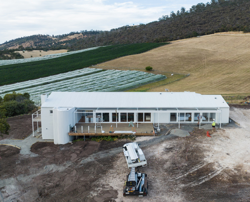 Overhead view of the residence at Pressing Matters Winery, which has undergone some alterations and revamping, featuring a deck with stunning views of the countryside
